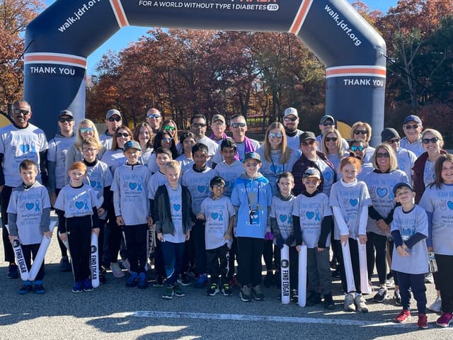 Team Bryson gathered under the JDRF walk start arch on a bright autumn morning, around thirty walkers in grey Peace Love Cure shirts