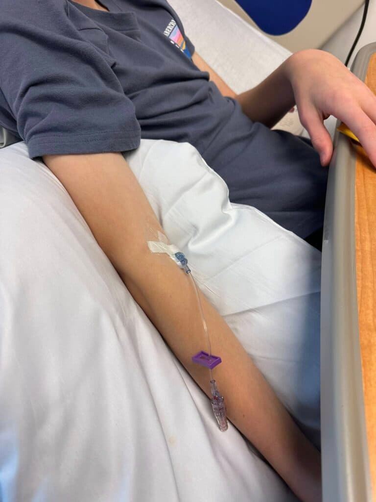 A child having blood drawn from the arm during TrialNet screening for type 1 diabetes